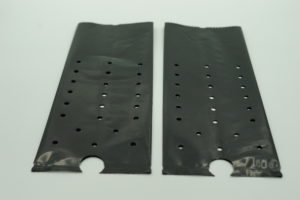 image of 2 black plant grow bags with punched holes laying flat 