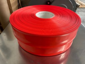 red layflat tubing on a roll