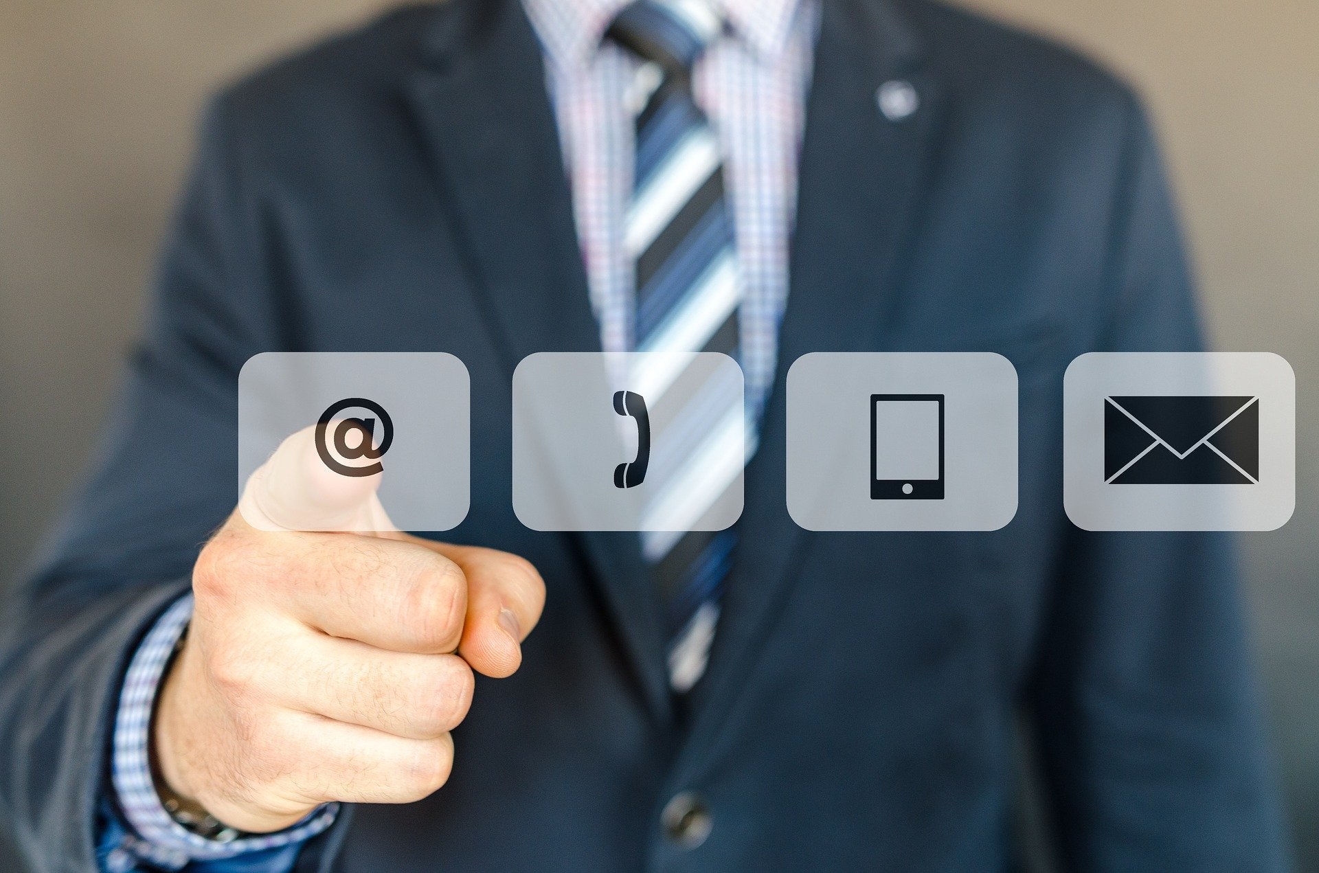 outside sales professional in a blue suit selecting internet icon, with 4 icons for internet, phone, mobile app, and email