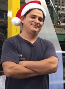 Image of a male staff production member with a Santa hat on.