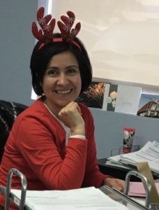 Image of an office staff member with reindeer ears.