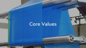 Image of blue poly film in extrusion plant with words that say "Core Values"