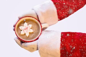 image of Santa's hands holding a cup of great-looking chocolate milk to symbolize excellent service and quality