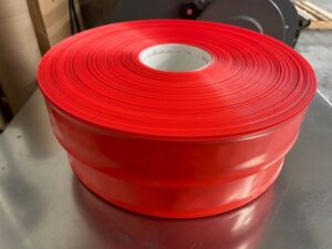 image of rolled-up, red layflat tubing 